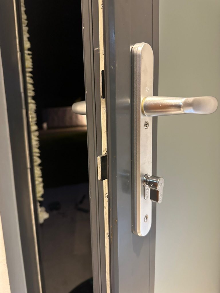 Satin lever handle on a grey aluminium door in Nuthall on an evening callout