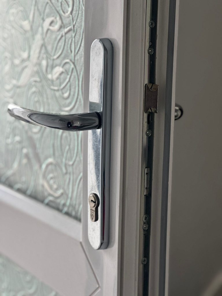3-star cylinder and chrome handle on a white uPVC door in Kimberley