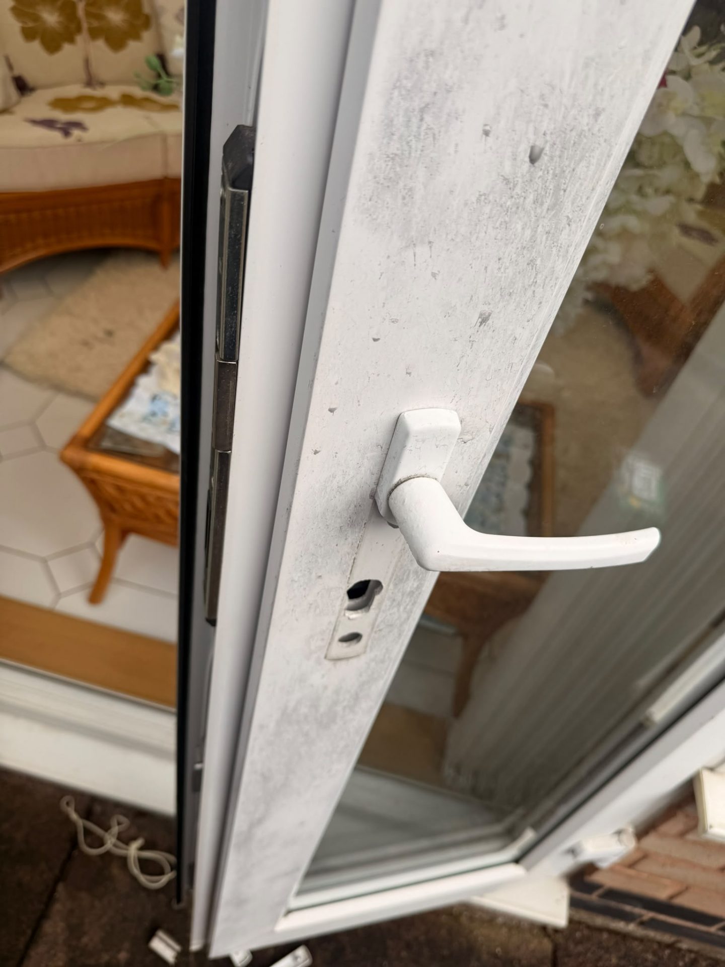 Damaged patio door handle and lock after burglars snapped the old cylinder