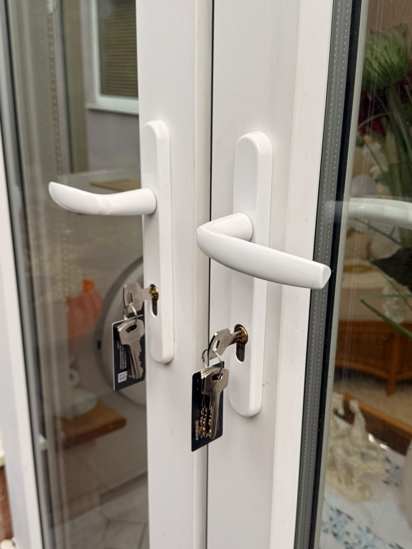 Patio door secured with a certified anti-snap cylinder and new handles after repair