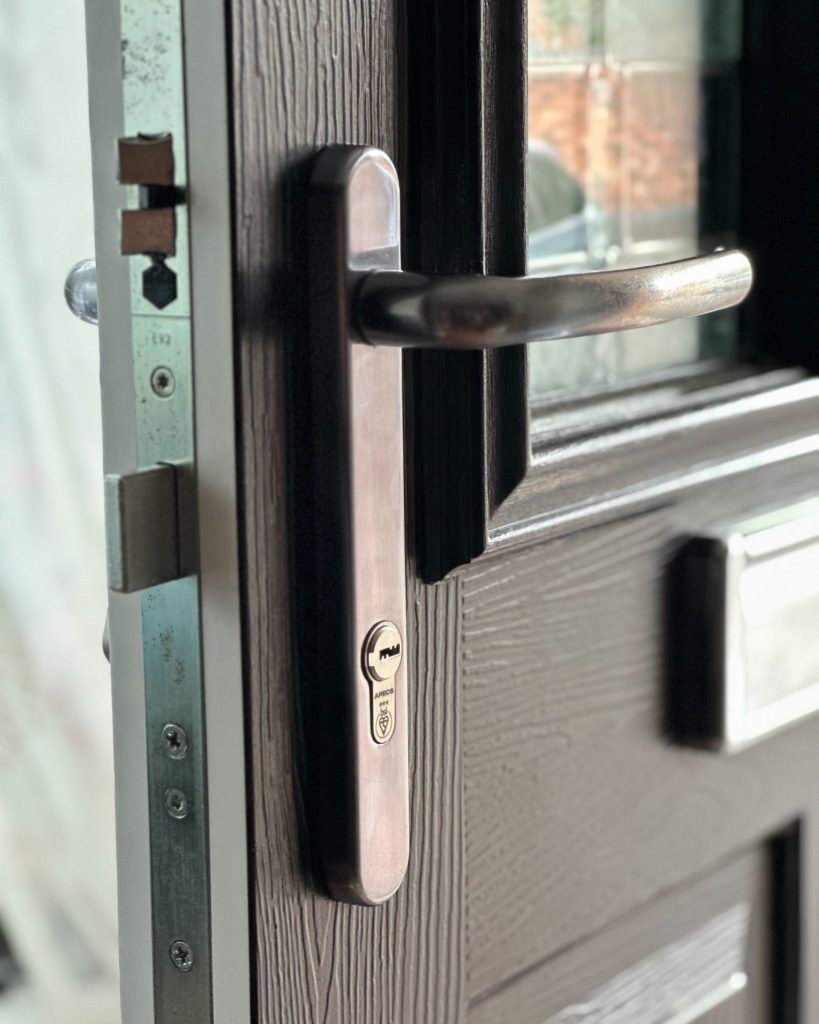 Multipoint hook bolts and 3-star cylinder on a dark composite door edge in Ilkeston