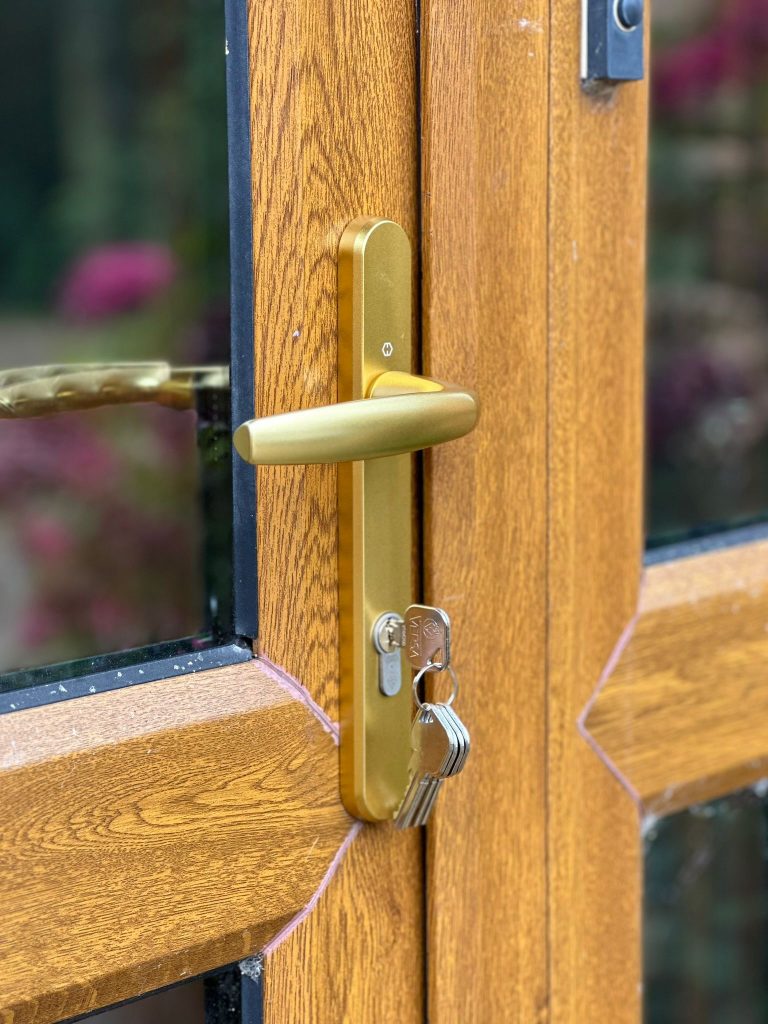 Golden oak door with new gold handle and cylinder in Burton Joyce