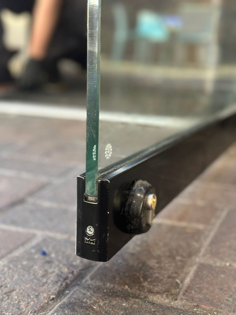 Bottom-rail lock on a glass shopfront door in Basford